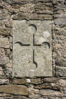 Detail of carved cross with round terminals on wall to S of decorative arch