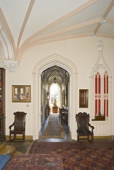 Interior. Ground floor, entrance hall, view from N showing cloister corridor and gothic niche