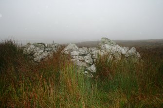 View showing the roofless building on the WNW of the cairn.