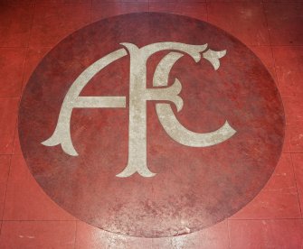 Interior. View of 'AFC' club crest set into the floor of the entrance foyer within the Main Stand of Pittodrie Stadium