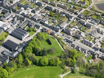 Oblique aerial view of Rothes Castle and Glen Spey Distillery, taken from the WSW.