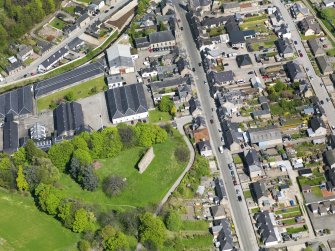 Oblique aerial view of Rothes Castle and Glen Spey Distillery, taken from the SSW.