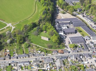 Oblique aerial view of Rothes Castle and Glen Spey Distillery, taken from the ESE.