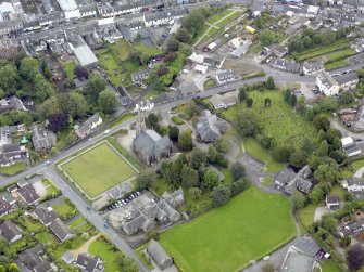 Oblique aerial view of Newton Stewart, centred on Penninghame Parish Church, taken from the WNW.