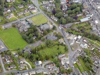 Oblique aerial view of Newton Stewart, centred on Penninghame Parish Church, taken from the S.
