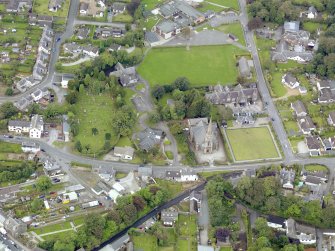 Oblique aerial view of Newton Stewart, centred on Penninghame Parish Church, taken from the ENE.