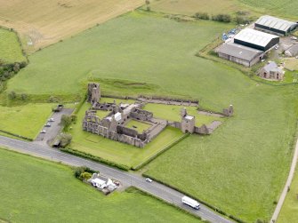 Oblique aerial view of Crossraguel Abbey, taken from the NW.