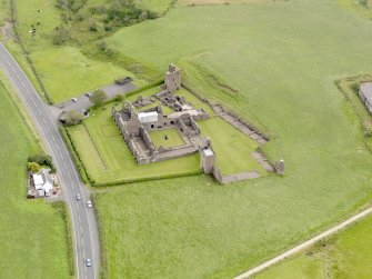 Oblique aerial view of Crossraguel Abbey, taken from the WNW.