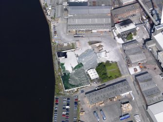 Oblique aerial view of Alloa Glassworks yard, taken from the SE.