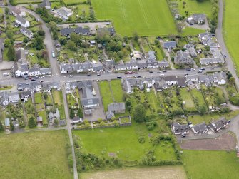 Oblique aerial view of the village centred on Gartmore Parish Church, taken from the NW.