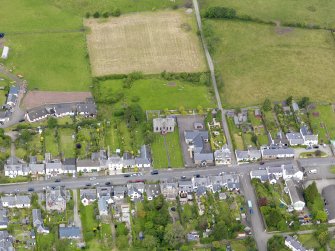 Oblique aerial view of the village centred on Gartmore Parish Church, taken from the SE.