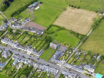 Oblique aerial view of the village centred on Gartmore Parish Church, taken from the ESE.