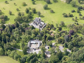 Oblique aerial view of Balloch Castle and stables, taken from the NE.