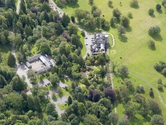 Oblique aerial view of Balloch Castle and stables, taken from the NNW.