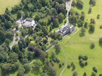 Oblique aerial view of Balloch Castle and stables, taken from the NW.