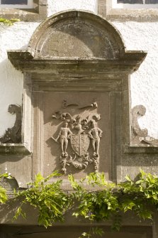 View of panel with coat of arms above main entrance.