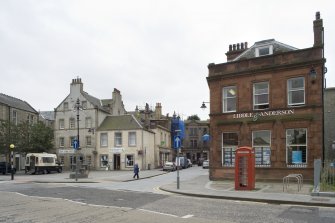 Street view looking towards Bo'ness Market Square taken from the North. The image shows 2 Market Street and 72-74 North Street and the Jubilee Fountain can be seen within the square. This photograph was taken as part of the Bo'ness Urban Survey to illustrate the character of the Town Centre Area of Townscape Character.