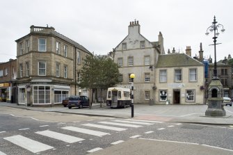 Street view looking towards Bo'ness Market Square taken from the North. The image shows 72-86 North Street and the Jubilee Fountain can be seen within the square to the right of the shot. This photograph was taken as part of the Bo'ness Urban Survey to illustrate the character of the Town Centre Area of Townscape Character.