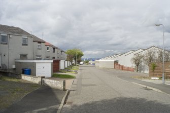 Street view showing partly terraced housing at Brick Row and Brewlands Avenue, Bo'ness, taken from the East. Each house is set back from the one before as they recede down the hill, and each has its own garage and direct access from the street. This photograph was taken as part of the Bo'ness Urban Survey to illustrate the character of the Hillcrest and Brewlands Area of Townscape Character.