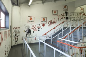 Interior. View of main supporters' staircase within Richard Donald stand, showing graffiti by local cartoonist.