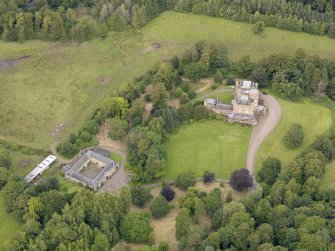 Oblique aerial view of Caprington Castle and stables, taken from the SSW.