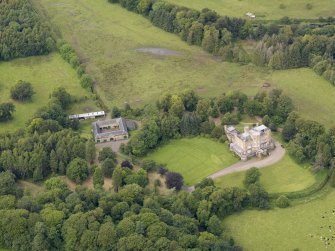 Oblique aerial view of Caprington Castle and stables, taken from the SE.