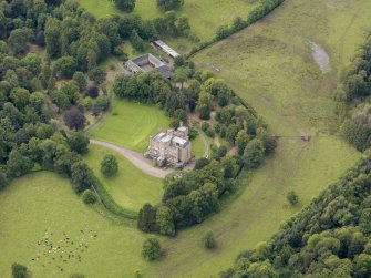 Oblique aerial view of Caprington Castle and stables, taken from the ENE.