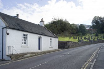 Street view showing 19th century cottage at 19 Church Wynd, Bo'ness, taken from the North-West. The burial ground of Bo'ness Parish Church, dating from the 17th century, can also be seen in this image. This photograph was taken as part of the Bo'ness Urban Survey to illustrate the character of the Corbiehall and Snab Area of Townscape Character.