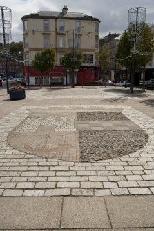 General view of town crest inlaid in paving on Guildford Square, Rothesay, Bute, from W