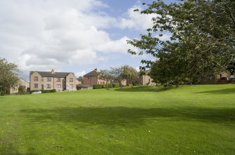 View of the East side of Deanfield Crescent, Bo'ness, taken from the North-West, looking across communal green space. This photograph was taken as part of the Bo'ness Urban Survey to illustrate the character of Deanfield Area of Townscape Character.