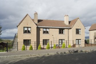 View of four-in-a-block housing on the North side of Deanfield Road, Bo'ness, taken from the South-East. This photograph was taken as part of the Bo'ness Urban Survey to illustrate the character of Deanfield Area of Townscape Character.