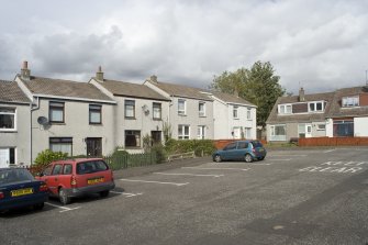 View of terraced housing arranged around a communal parking square, off the main thoroughfare of Castlehill, Bo'ness. The image shows 2-12 Castlehill, taken from the South-West. This photograph was taken as part of the Bo'ness Urban Survey to illustrate the character of Deanfield Area of Townscape Character.