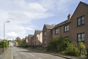 General street view of the South side of Deanfield Crescent (Nos 1-33), Bo'ness, taken from the West. This photograph was taken as part of the Bo'ness Urban Survey to illustrate the character of Deanfield Area of Townscape Character.