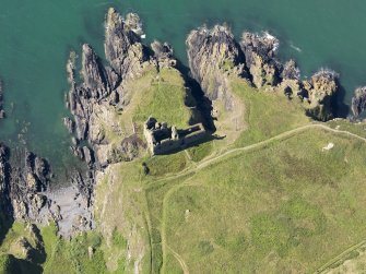 Oblique aerial view of Dunskey Castle, taken from the NE.