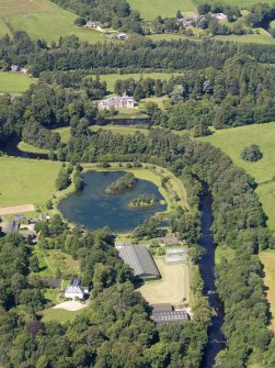 Oblique aerial view looking along the River Doon, with Monkwood in the foreground and Auchendrane Castle beyond, taken from the ESE.