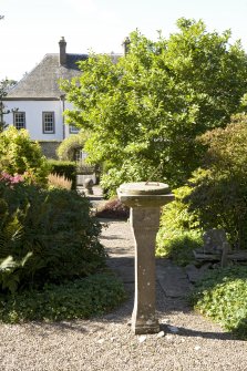 View from east with ball sundial and house in background.