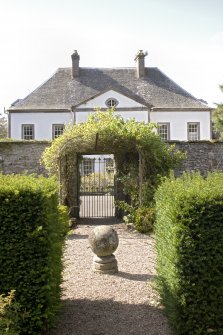 West gate to garden and house beyond  from east.