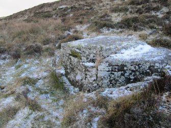 Corr: hut circle looking SW, showing flat back stone with level platform below