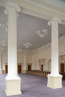 Interior. 1st floor, main hall, view through columns to SW