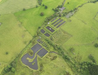 Oblique aerial view of Howietoun Fish Farm, taken from the WNW.