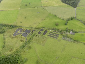 Oblique aerial view of Howietoun Fish Farm, taken from the SW.