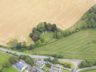 Oblique aerial view of St Lolan's Church, taken from the SSW.