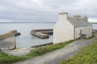 View from upper path looking across Keiss harbour and the rear of the warehouse, taken from N