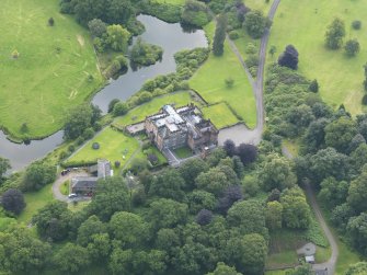 Oblique aerial view of Raehills House and stables, taken from the WNW.