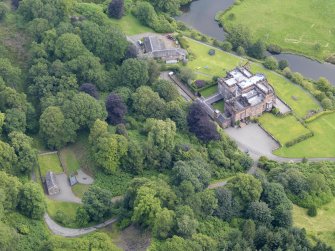 Oblique aerial view of Raehills House and stables, taken from the SSW.