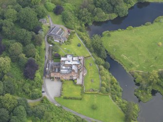 Oblique aerial view of Raehills House and stables, taken from the SSE.