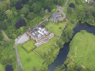 Oblique aerial view of Raehills House and stables, taken from the SE.