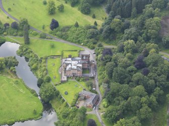 Oblique aerial view of Raehills House and stables, taken from the N.