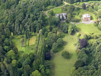 Oblique aerial view of Rammerscales House and policies, taken from the ENE.