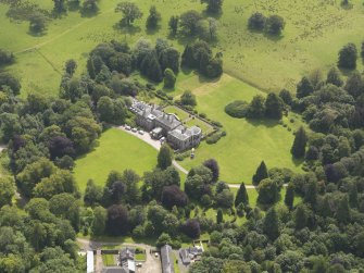 Oblique aerial view of Springkell House and stables, taken from the NNW.